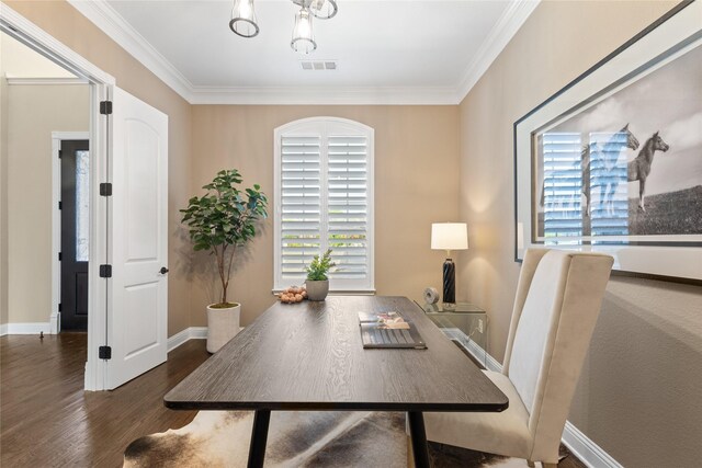 office area featuring baseboards, visible vents, wood finished floors, and ornamental molding
