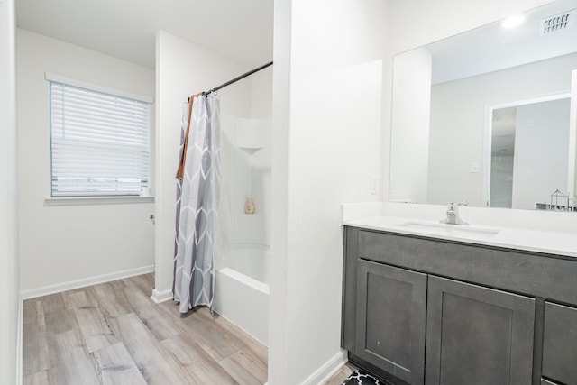 bathroom with shower / tub combo, vanity, and wood-type flooring