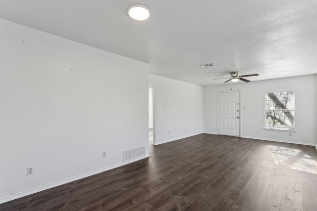 interior space with ceiling fan, dark hardwood / wood-style flooring, and a textured ceiling