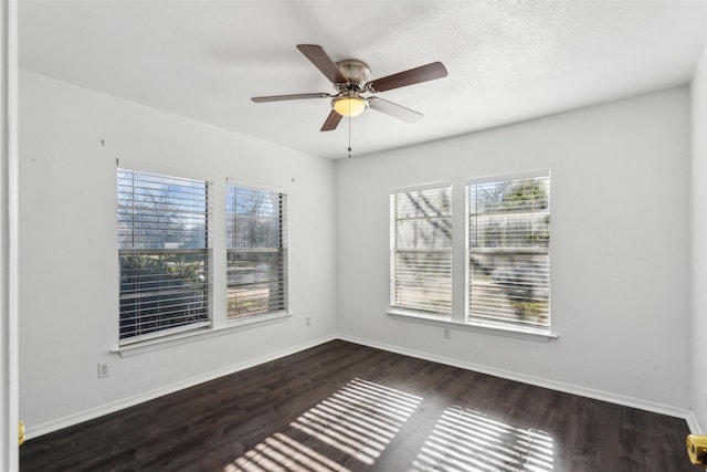 empty room featuring ceiling fan and dark hardwood / wood-style flooring