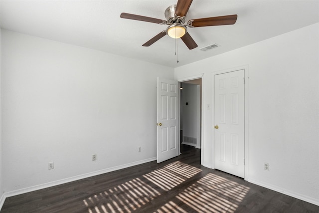 unfurnished bedroom featuring ceiling fan and dark hardwood / wood-style floors