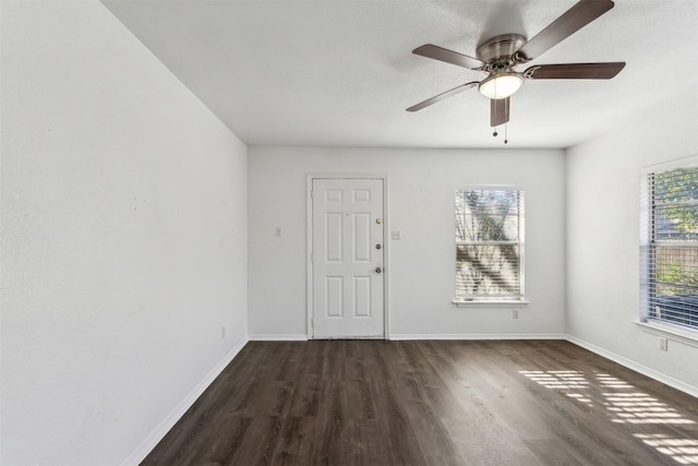 unfurnished room featuring ceiling fan and dark hardwood / wood-style flooring