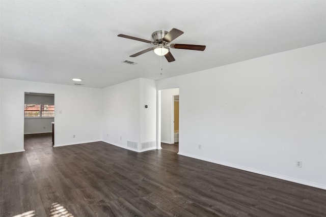 empty room with ceiling fan and dark wood-type flooring