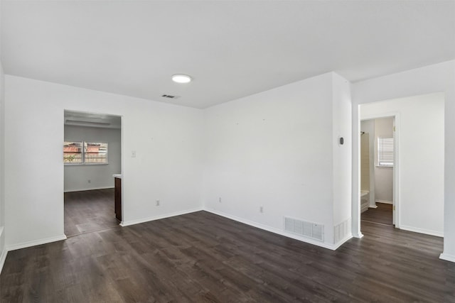 unfurnished room with dark hardwood / wood-style floors