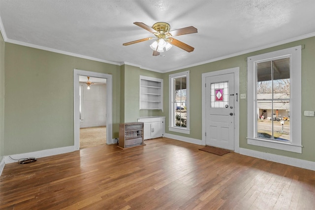 interior space with crown molding, hardwood / wood-style floors, and a textured ceiling