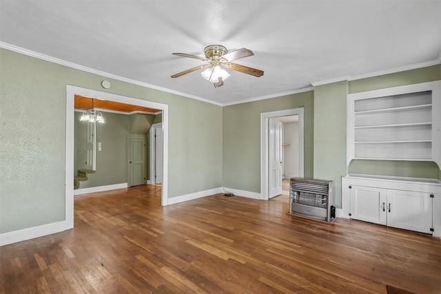 interior space with built in shelves, ceiling fan with notable chandelier, crown molding, and dark wood-type flooring