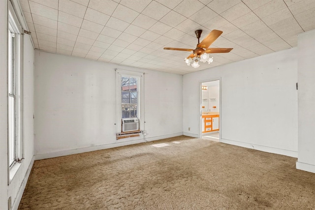 empty room featuring cooling unit, ceiling fan, and carpet floors