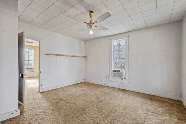 carpeted spare room featuring cooling unit, a wealth of natural light, and ceiling fan