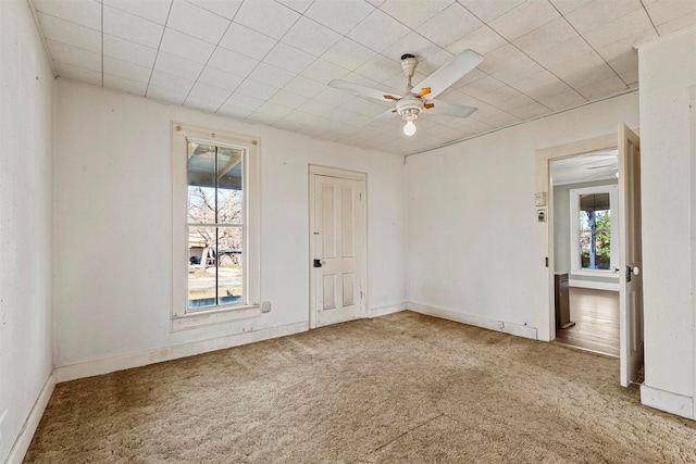 spare room with carpet floors and ceiling fan