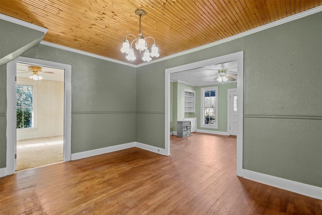 unfurnished dining area with hardwood / wood-style floors, an inviting chandelier, crown molding, built in features, and wood ceiling