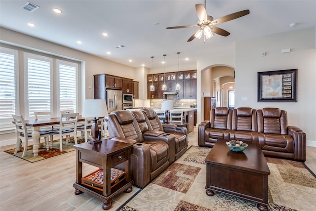 living room featuring light hardwood / wood-style floors and ceiling fan