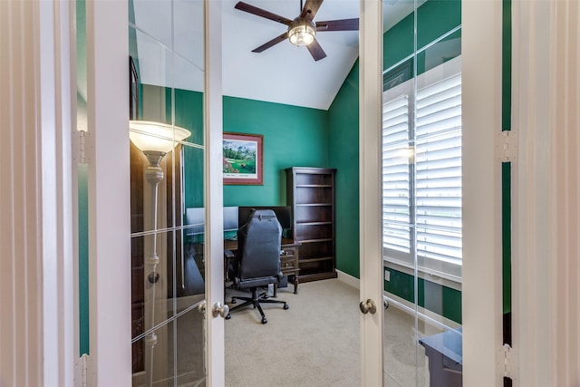 carpeted office featuring lofted ceiling, french doors, and ceiling fan