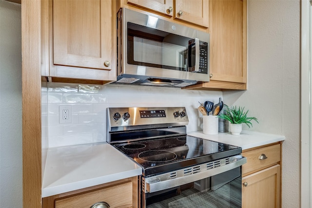 kitchen with light brown cabinetry, backsplash, and stainless steel appliances