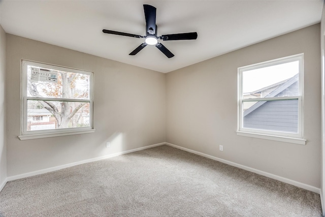 unfurnished room with ceiling fan and carpet floors