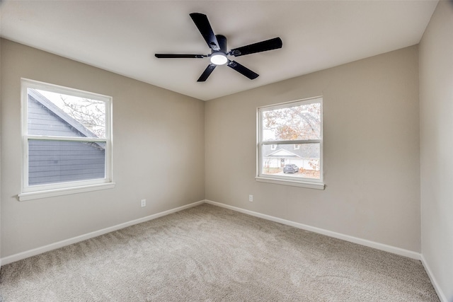 unfurnished room featuring carpet flooring, ceiling fan, and a healthy amount of sunlight