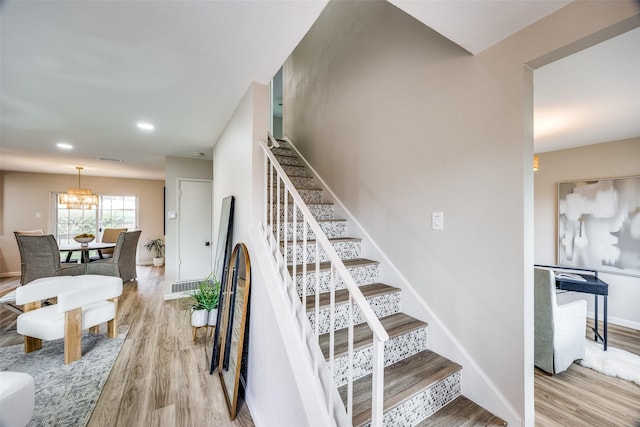 stairway featuring wood-type flooring