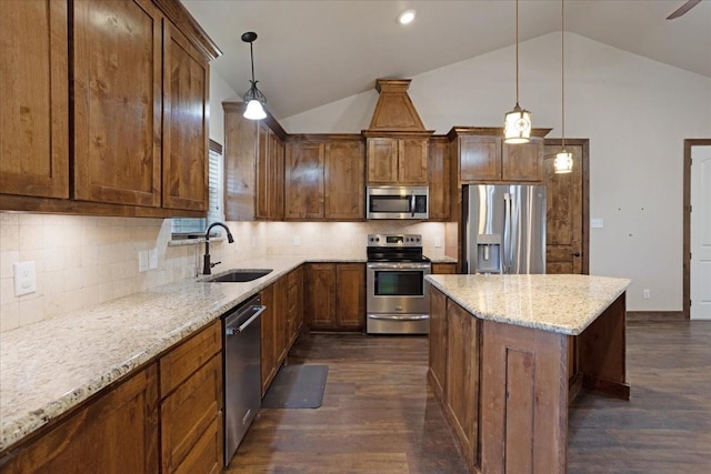 kitchen with pendant lighting, backsplash, sink, and stainless steel appliances