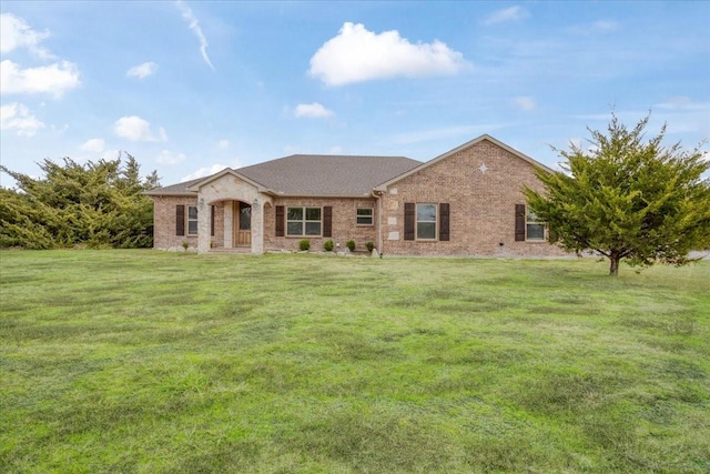 view of front facade with a front lawn and brick siding