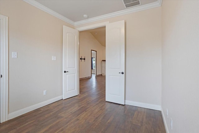 unfurnished room with ornamental molding, dark wood-style flooring, visible vents, and baseboards