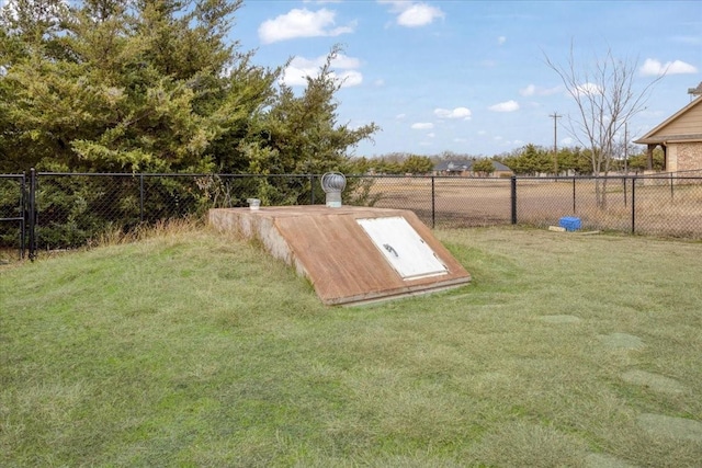 view of storm shelter featuring a yard and fence