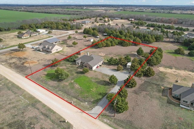 birds eye view of property with a rural view