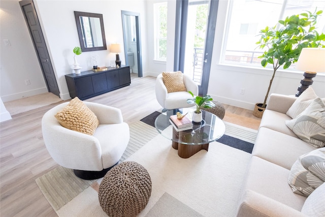 living room with plenty of natural light and light hardwood / wood-style floors