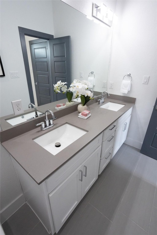 bathroom with tile patterned flooring and vanity