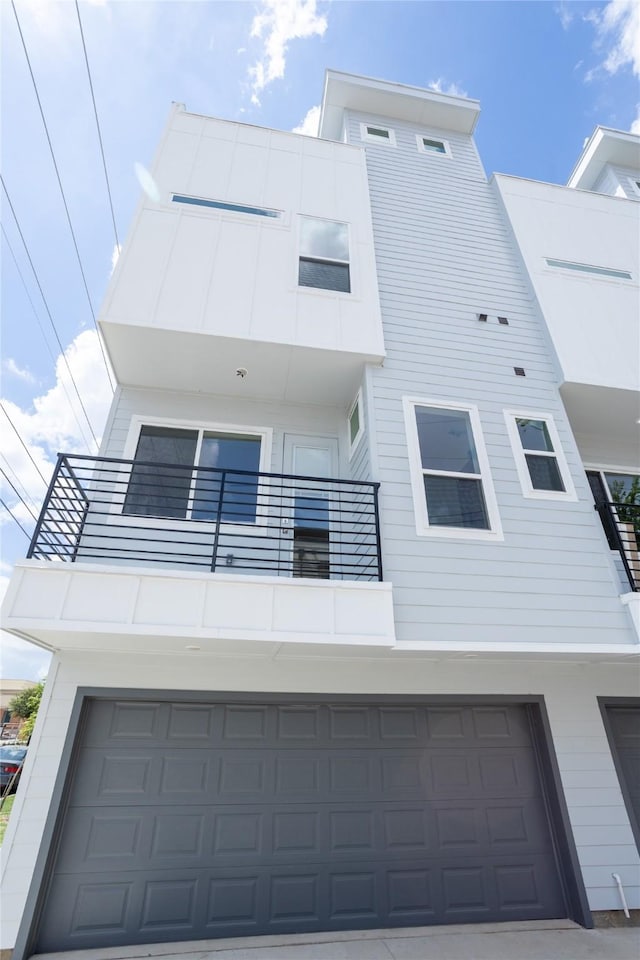 exterior space with a garage and a balcony