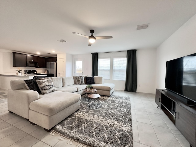 tiled living room with ceiling fan