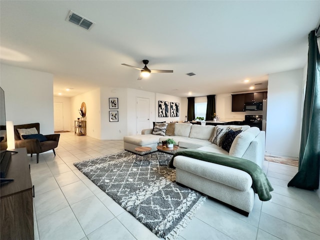 living room with ceiling fan and light tile patterned flooring