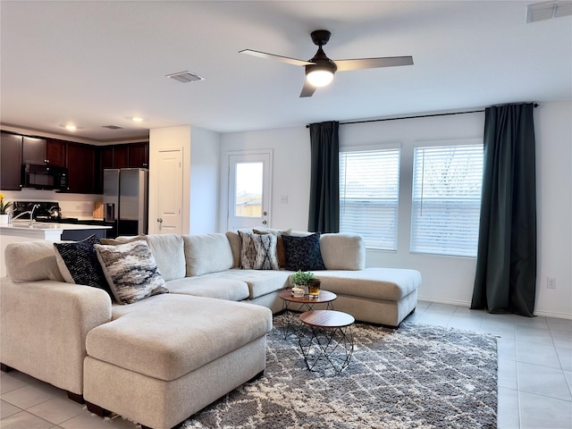 tiled living room with ceiling fan