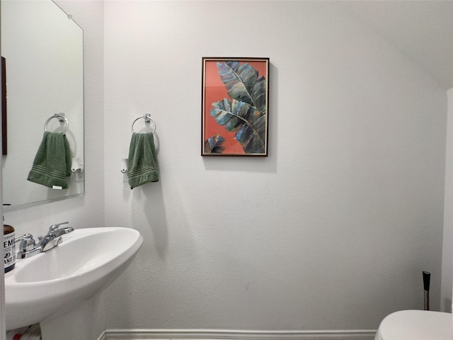 bathroom featuring toilet and sink