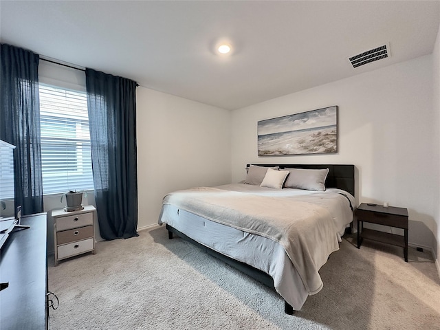 bedroom featuring light carpet