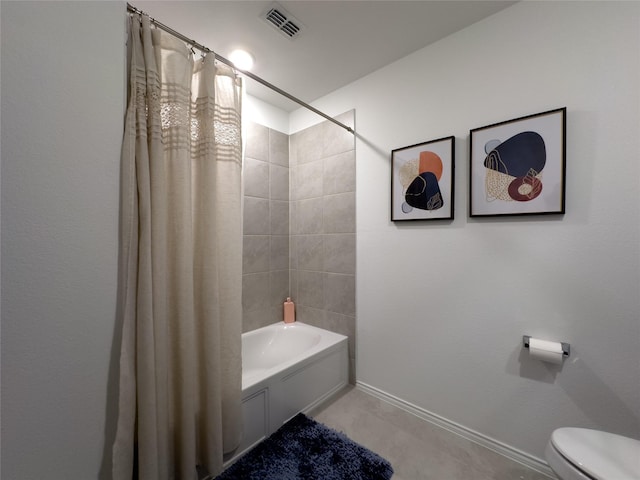 bathroom with tile patterned flooring, shower / bath combo, and toilet