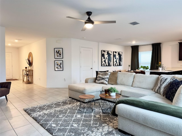 tiled living room with ceiling fan