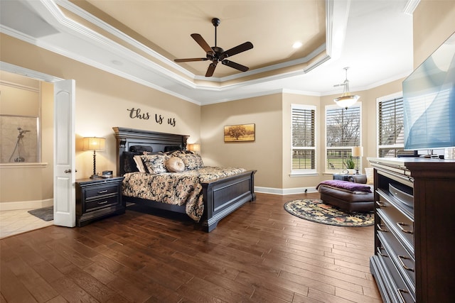 bedroom with a tray ceiling, ceiling fan, dark wood-type flooring, and ornamental molding