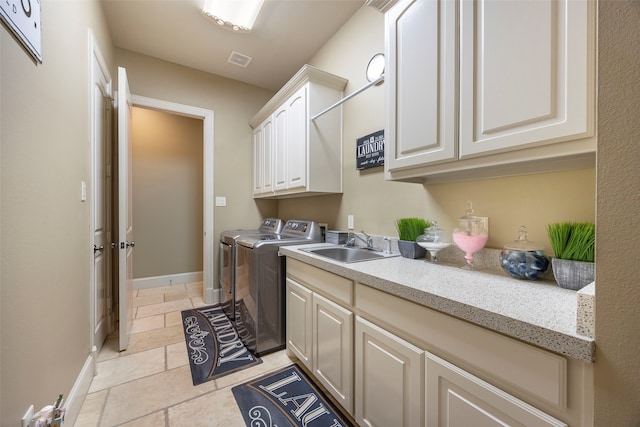 laundry room with washer and dryer, cabinets, and sink