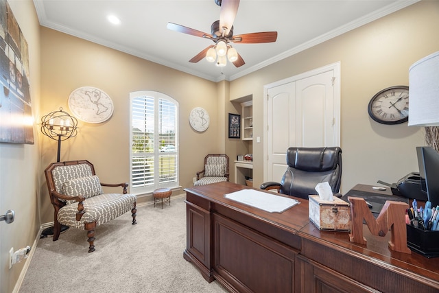 carpeted office space featuring ceiling fan and ornamental molding