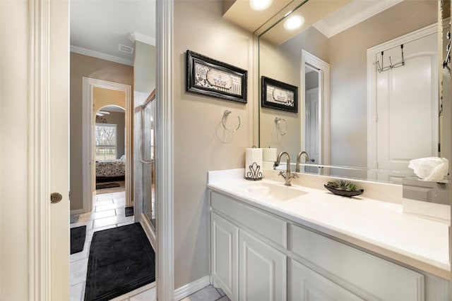 bathroom with tile patterned flooring, vanity, and ornamental molding