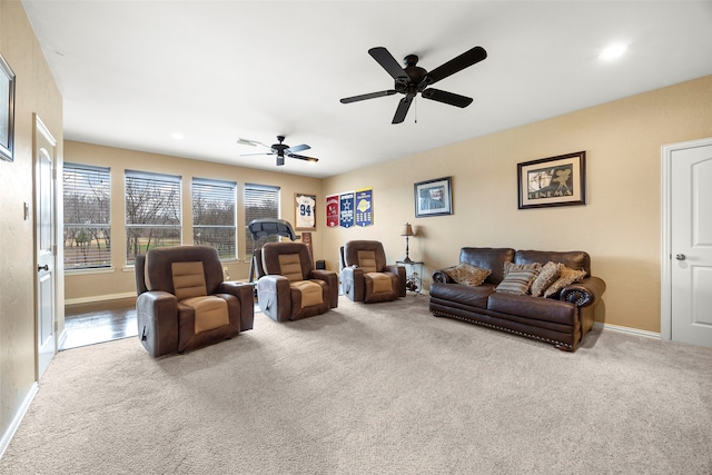 living room featuring carpet and ceiling fan