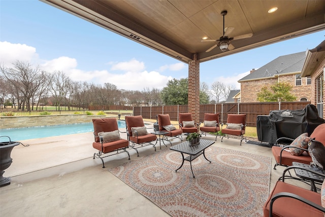 view of patio featuring a fenced in pool, outdoor lounge area, ceiling fan, and area for grilling