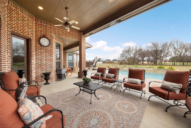 view of patio / terrace with a fenced in pool, ceiling fan, and an outdoor hangout area