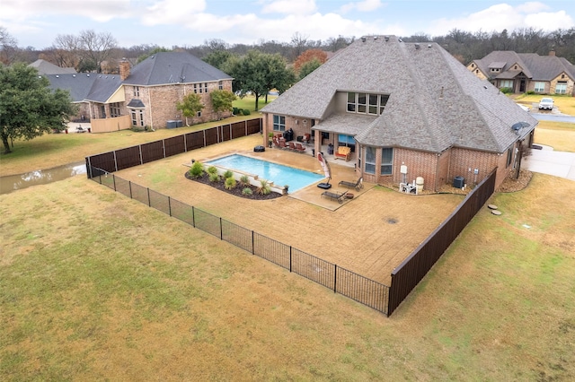 view of pool with a yard and a patio