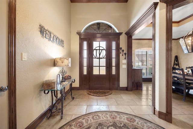 foyer featuring a high ceiling and crown molding