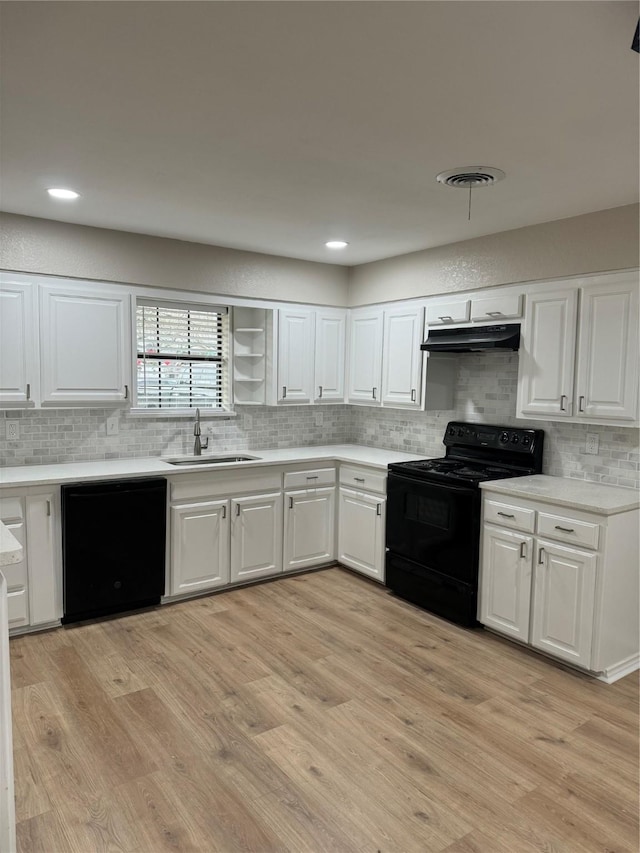 kitchen featuring white cabinetry, sink, and black appliances