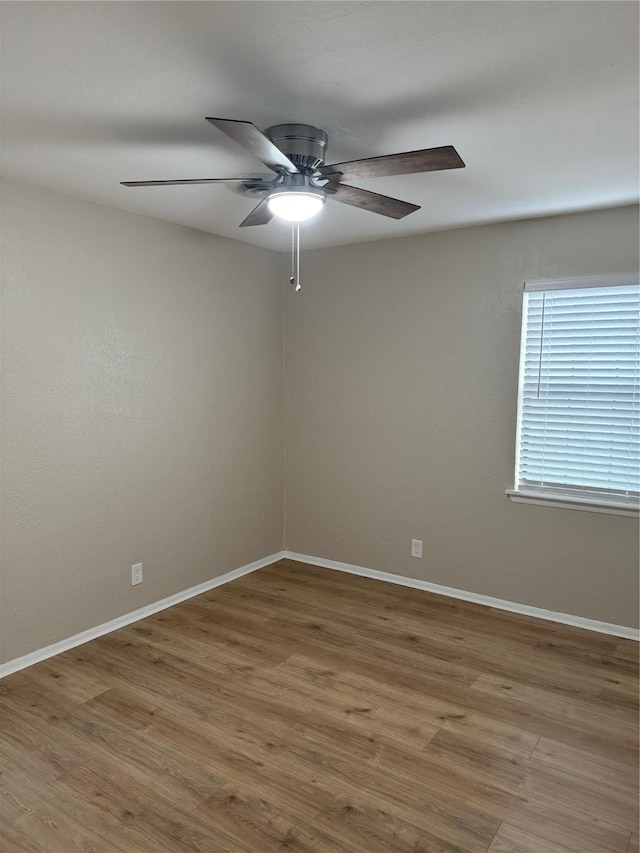 empty room with wood-type flooring and ceiling fan