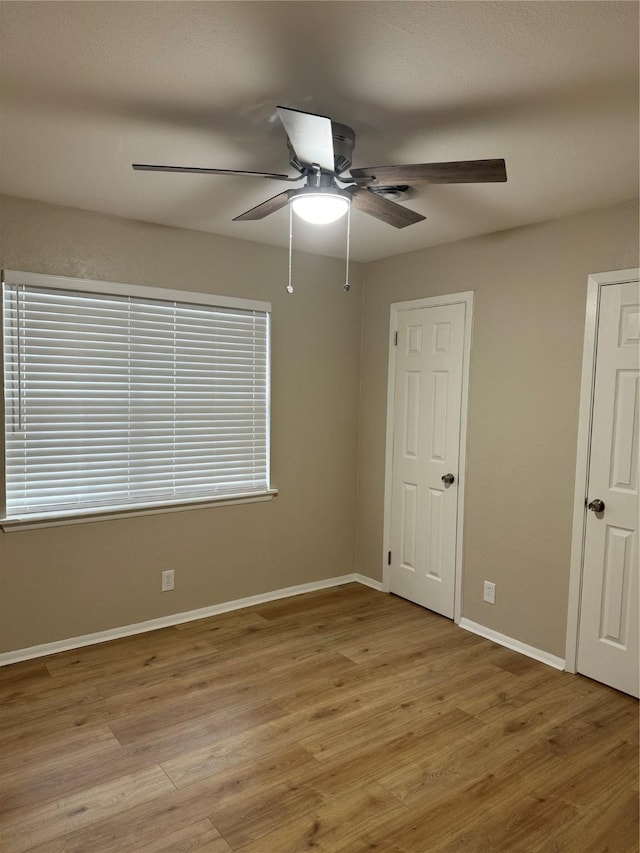 unfurnished room with light hardwood / wood-style flooring and ceiling fan