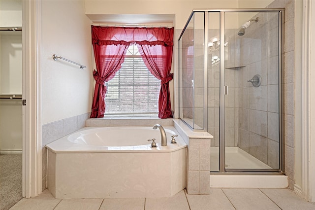 bathroom with tile patterned flooring and independent shower and bath