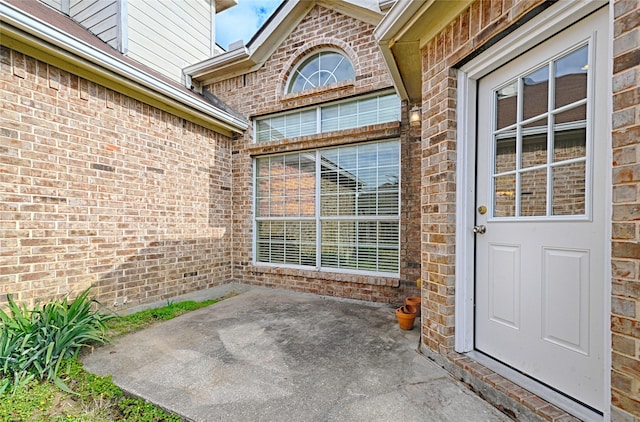 entrance to property featuring a patio