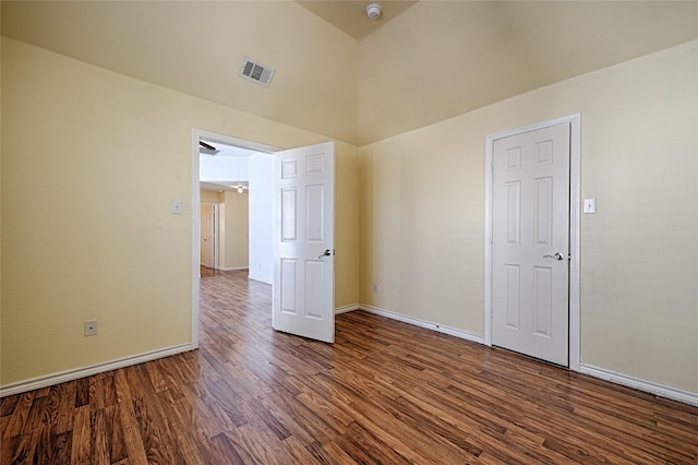 unfurnished bedroom featuring hardwood / wood-style floors and vaulted ceiling